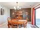 Charming dining room with wood table set, a china cabinet, and a sliding glass door with natural light at 11651 E Yale Way, Aurora, CO 80014
