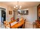 Charming dining room featuring a chandelier and a wooden table set for four at 11651 E Yale Way, Aurora, CO 80014