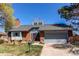 Well-maintained exterior with brick accents, mature landscaping, attached garage, and a welcoming curb appeal at 11651 E Yale Way, Aurora, CO 80014