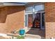 Charming front entryway with brick facade, secure storm door, and a welcoming entrance at 11651 E Yale Way, Aurora, CO 80014