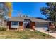 Charming red brick single-Gathering home with a two-car garage and manicured front lawn at 11651 E Yale Way, Aurora, CO 80014