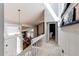Sunlit hallway featuring stairs to main level and views of living room at 11651 E Yale Way, Aurora, CO 80014