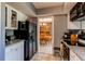 Kitchen view with stainless steel refrigerator, granite countertops, and modern appliances at 11651 E Yale Way, Aurora, CO 80014