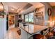 Well-lit kitchen boasts modern appliances, granite counters, and tile flooring at 11651 E Yale Way, Aurora, CO 80014