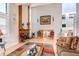 Light filled living room with tall ceilings, clerestory windows, brick fireplace and open staircase at 11651 E Yale Way, Aurora, CO 80014