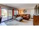 Cozy living room with large sectional, sliding glass doors to backyard at 11651 E Yale Way, Aurora, CO 80014