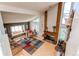 Light filled living room with hardwood floors, a red brick fireplace, and a charming window seat overlooking the yard at 11651 E Yale Way, Aurora, CO 80014