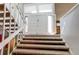 Carpeted staircase leading to a bright two-story foyer with grand double doors, an open concept design at 11651 E Yale Way, Aurora, CO 80014