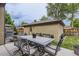 Backyard patio features a stone dining table with an outdoor kitchen and grilling station at 1410 S Elizabeth St, Denver, CO 80210