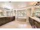 Bright bathroom features a soaking tub, dual vanities, and tile flooring at 1410 S Elizabeth St, Denver, CO 80210