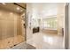 Bright bathroom showcases a glass-enclosed shower and a luxurious soaking tub at 1410 S Elizabeth St, Denver, CO 80210