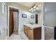 Bathroom features a single sink vanity with a tile countertop and a shower with glass door at 1410 S Elizabeth St, Denver, CO 80210