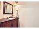 Elegant powder room has a vanity with dark countertops and an ornate mirror at 1410 S Elizabeth St, Denver, CO 80210