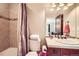 Bathroom showcases a shower with tile surround, single sink vanity and neutral wall color at 1410 S Elizabeth St, Denver, CO 80210