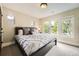 Bedroom featuring plush bedding, neutral walls, and lots of natural light at 1410 S Elizabeth St, Denver, CO 80210