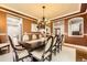 Warm dining room with a grand table set for eight, complemented by rich trim, a chandelier, and ample light at 1410 S Elizabeth St, Denver, CO 80210
