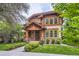 Charming home featuring a beautiful wood facade, brick accents, and a welcoming entryway with landscaped yard at 1410 S Elizabeth St, Denver, CO 80210