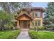 Charming home featuring a beautiful wood facade, brick accents, and a welcoming entryway with landscaped yard at 1410 S Elizabeth St, Denver, CO 80210