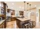 Spacious kitchen with dark wood cabinets, granite countertops, stainless steel appliances, and a center island at 1410 S Elizabeth St, Denver, CO 80210