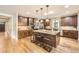 Large kitchen with dark wood cabinets, granite countertops, stainless steel appliances, and spacious center island at 1410 S Elizabeth St, Denver, CO 80210