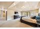 Spacious main bedroom has a tray ceiling, plush carpet, and private balcony access at 1410 S Elizabeth St, Denver, CO 80210