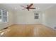 Bright, spacious bedroom with hardwood floors, natural light, and a ceiling fan at 1111 Kearney St, Denver, CO 80220