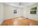 Large bedroom with hardwood floors, natural light, and a ceiling fan at 1111 Kearney St, Denver, CO 80220