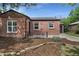 Beautiful brick home with tidy landscaping, featuring a well-maintained lawn and attached one car garage at 1111 Kearney St, Denver, CO 80220