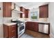 Cozy kitchen with stainless appliances, stone tile floor and ample counter space at 1111 Kearney St, Denver, CO 80220