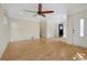 Spacious living area featuring pristine hardwood floors, neutral walls, and a large ceiling fan at 1111 Kearney St, Denver, CO 80220