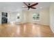 Inviting living room with shiny hardwood floors, complemented by a built-in bench and view to the kitchen at 1111 Kearney St, Denver, CO 80220