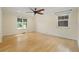Bright main bedroom featuring hardwood flooring, neutral walls, and natural light from large windows at 1111 Kearney St, Denver, CO 80220