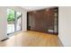 Bright office with hardwood floors, built-in shelves and a Murphy bed with light from a sliding glass door at 1111 Kearney St, Denver, CO 80220