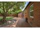 View of the backyard featuring a brick patio area and mature trees at 1111 Kearney St, Denver, CO 80220