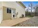 This backyard offers a cozy patio, grill, and a nice artificial turf surrounded by decorative rock at 8571 S Estes St, Littleton, CO 80128