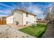 The backyard features a back door, patio, grill, artificial turf, rocks, and a hammock at 8571 S Estes St, Littleton, CO 80128