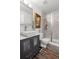 Modern bathroom featuring a glass enclosed shower, vanity with storage, and neutral paint at 8571 S Estes St, Littleton, CO 80128