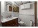 Half bathroom featuring classic fixtures and cabinets at 8571 S Estes St, Littleton, CO 80128