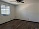 Bedroom featuring wood floors, neutral walls, and a window for natural light at 8571 S Estes St, Littleton, CO 80128