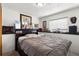 Bedroom featuring bed, shelving, art pieces, and large window at 8571 S Estes St, Littleton, CO 80128