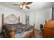Comfortable bedroom featuring wood-look floors, ceiling fan, and ample closet space, providing a relaxing retreat at 8571 S Estes St, Littleton, CO 80128