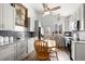 Eat-in kitchen featuring granite countertops, white cabinetry, mosaic tile backsplash, and stainless steel appliances at 8571 S Estes St, Littleton, CO 80128