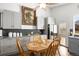 Stylish kitchen with granite countertops, white cabinetry, stainless steel appliances, and a cozy breakfast nook at 8571 S Estes St, Littleton, CO 80128