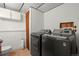 Laundry room with gray washer and dryer at 8571 S Estes St, Littleton, CO 80128