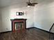 Living room featuring a fireplace, ceiling fan, and wood-look flooring at 8571 S Estes St, Littleton, CO 80128