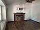 Bright living room featuring a fireplace, ceiling fan, and wood-look flooring at 8571 S Estes St, Littleton, CO 80128