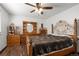 Spacious main bedroom featuring detailed wood furnishings and a ceiling fan for added comfort at 8571 S Estes St, Littleton, CO 80128
