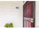 Exterior entrance to condo unit 208 with secure storm door and tidy landscaping at 8335 Fairmount Dr # 10-208, Denver, CO 80247
