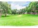 Expansive green space with mature trees and seating areas for relaxing at 8335 Fairmount Dr # 10-208, Denver, CO 80247
