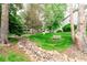 Quiet community space with walking path and bench seating shaded by trees at 8335 Fairmount Dr # 10-208, Denver, CO 80247